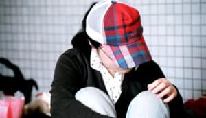 teen wears plaid cap