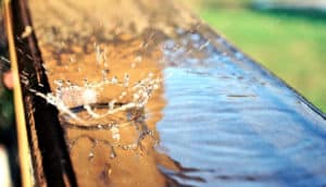 water drop splashing on deck railing