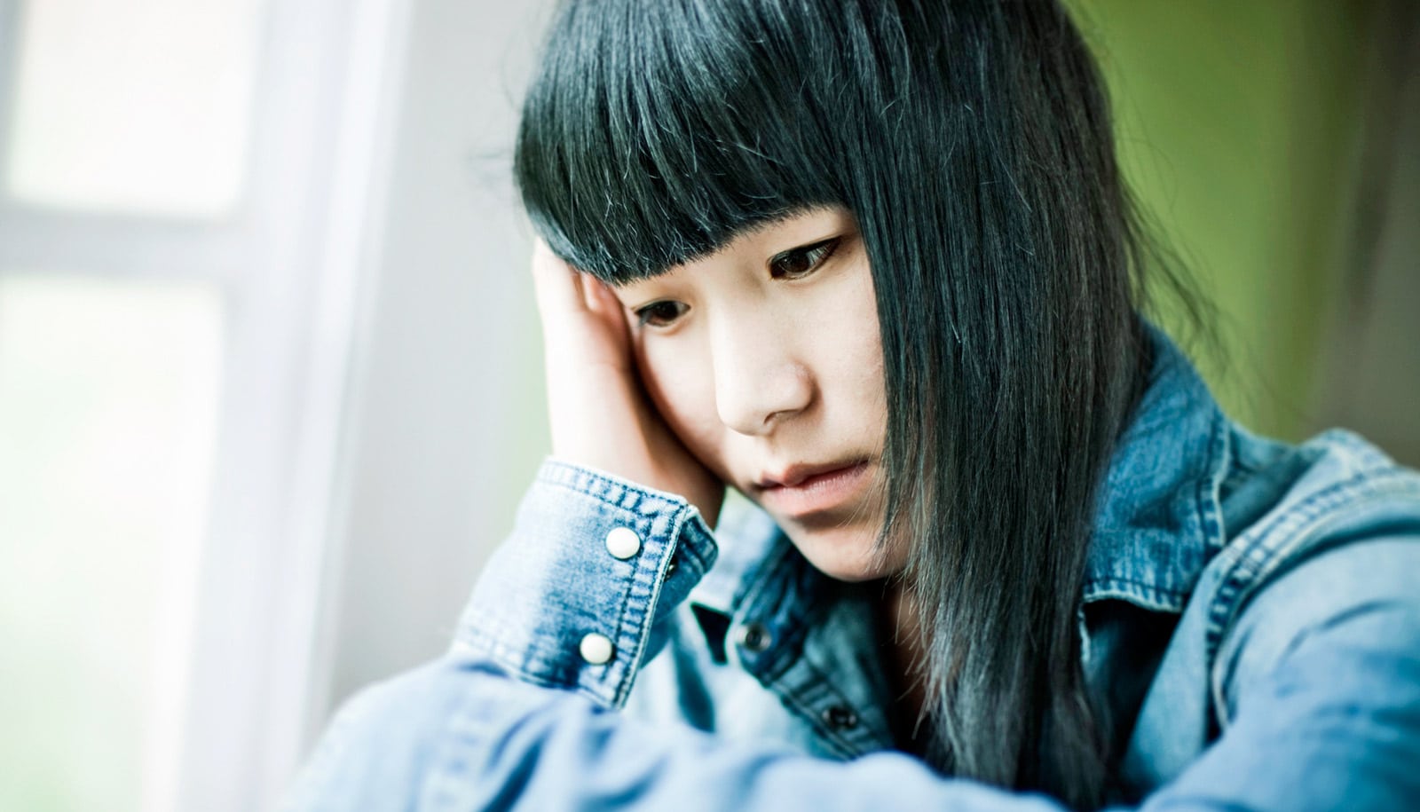 anxious girl with black hair, denim shirt