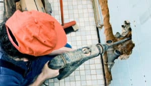 man drilling through the wall