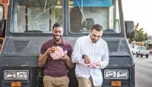 guy friends eat at taco truck