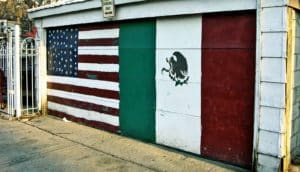 Mexican and American flags on a garage