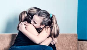 mom and daughter hug