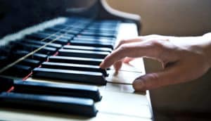 one hand playing piano