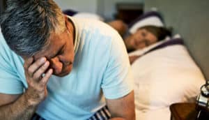 sleepless man sitting up