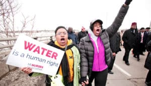 two women walk in Flint protest