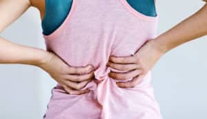 Pink shirt scrunched up with back pain