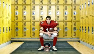 football player in yellow locker room