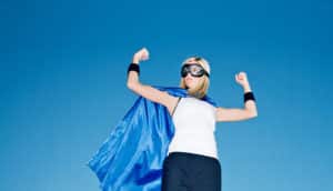 power poses - woman in superhero costume flexes
