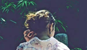 unrecognizable woman touches ear