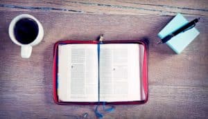 bible on table with coffee