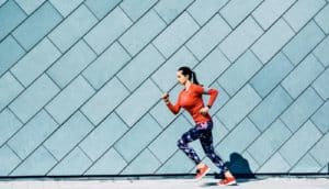 jogger in red against a blue wall