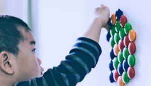 kid playing with fridge magnets