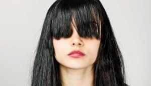 bangs cover woman's eyes