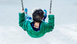 child swinging alone