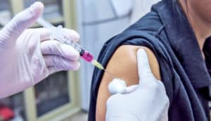 flu injection into woman's arm