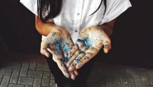 blue glitter on palms of hands