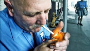 man lighting cigarette
