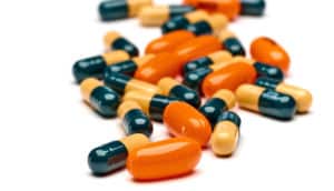 orange and black pills on white