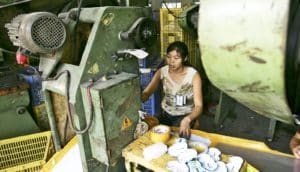 woman uses machine in Chinese factory