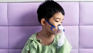 boy wearing breathing mask (cystic fibrosis concept)