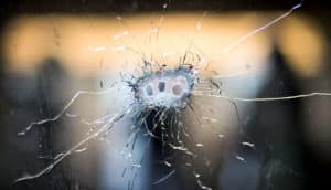 bullet holes in glass (gun laws and domestic partner violence concept)