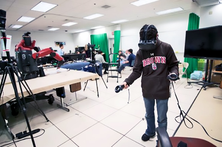 student controlling robot with VR headset