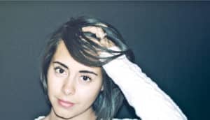 woman with hand on head