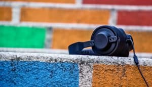 headphones on a colorful brick wall (hearing concept)