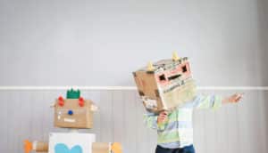 cardboard robot and kid in robot costume hat