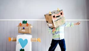 cardboard robot and child in robot costume hat