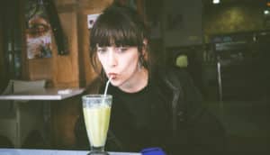 woman drinks milkshake with straw