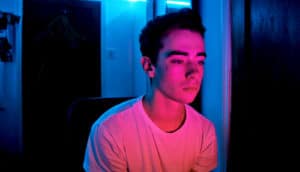 young man lighted by neon (depression and anxiety concept)
