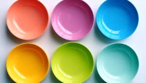 six rainbow-colored bowls on white