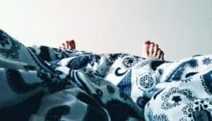 woman's toes under blanket