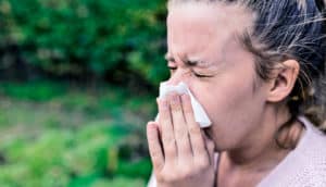 sneezing woman (virus infection concept)