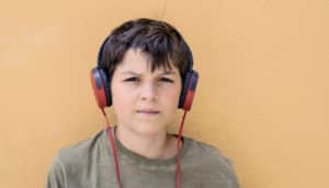 young teen boy with headphones (fathers, rejection, and social anxiety concept)
