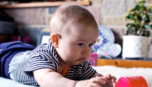 baby crawling towards cup (babies + crawling concept)