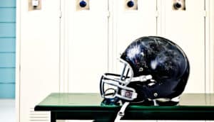 football helmet in locker room (CTE concept)