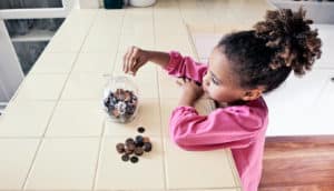 young girl saving money