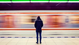 man waiting at subway station