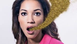 woman with gold glitter coming from mouth