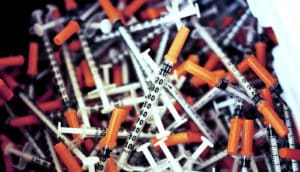 used needles at a needle exchange (opioid addiction concept)