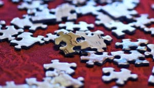 puzzle pieces on red cloth (genetic variations concept)