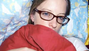 sick woman in bed (flu concept)