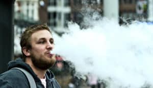 vaping man on the street (e-cigarettes concept)
