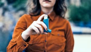 woman holding inhaler