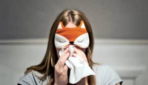 woman in fox sleeping mask with flu