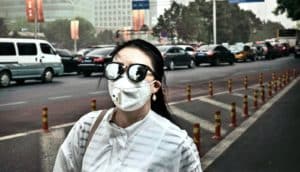 woman in face mask in China (air pollution concept)