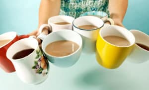 person holds 8 cups of coffee